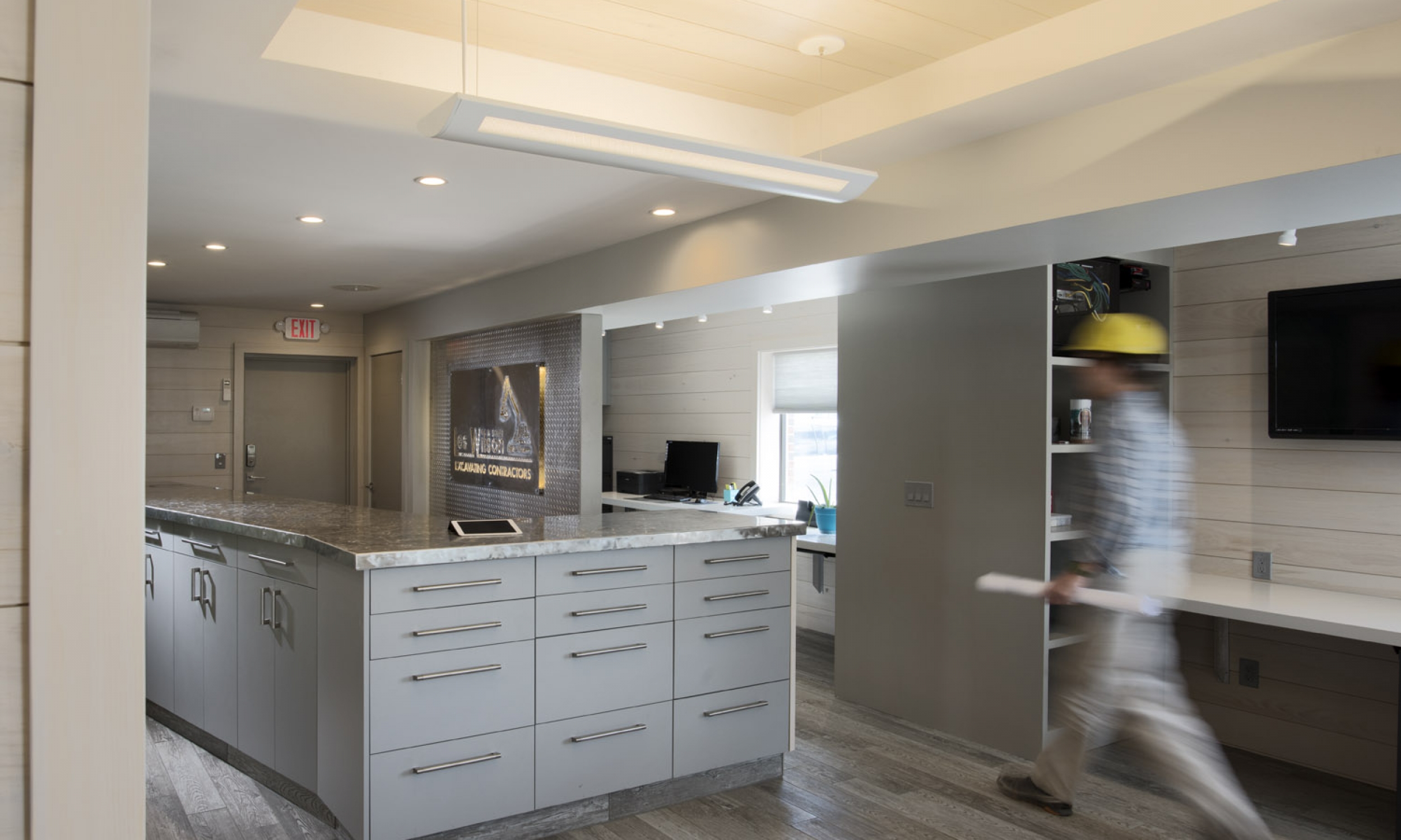 Serpentine Desk Serpentine Desk, Custom cabinets, swirled stainless steel counter, tile floor, suspended LED lights, Maine Architect